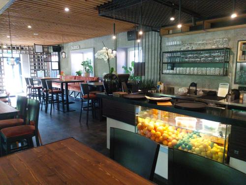 a restaurant with a bar with a display of fruit at Hotel Fabrica in Liberec