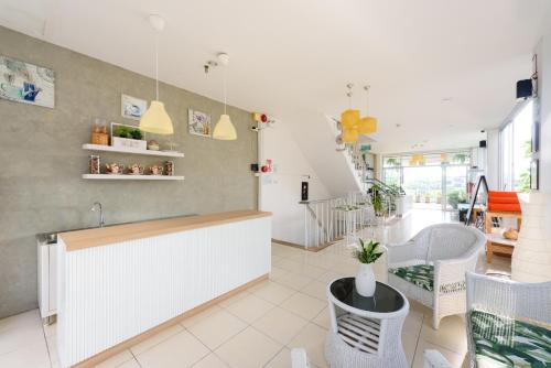 a restaurant with a counter and chairs in a room at Little Home Ao Nang in Ao Nang Beach