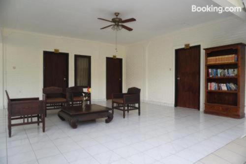 a living room with furniture and a ceiling fan at Sarinande Hotel in Seminyak