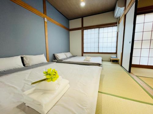 Giường trong phòng chung tại 晴空民宿 Sora House 晴空塔徒步圈 整栋出租