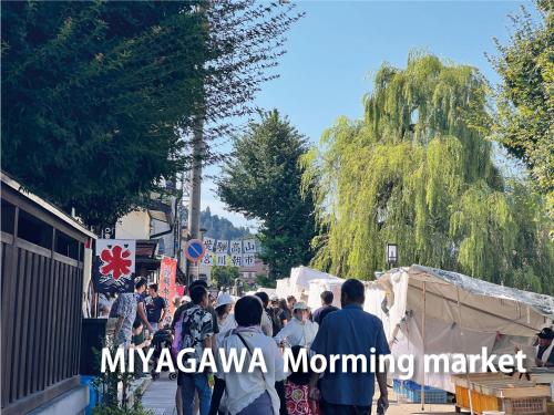 a crowd of people walking down a street at Backpackers Hida Takayama in Takayama