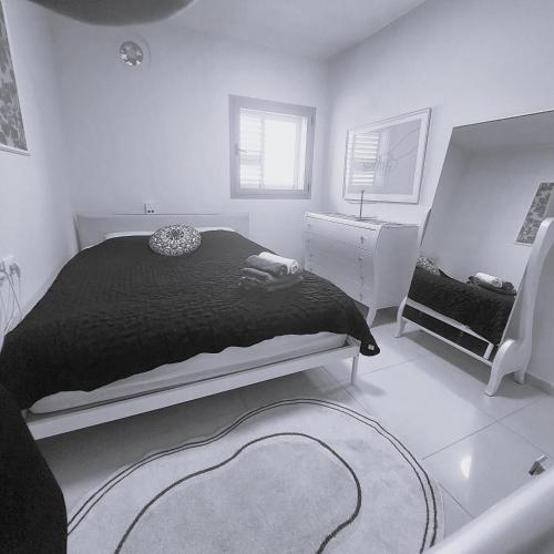 アシュドッドにあるapartments with separate kitchen by the seaのベッドと鏡のある白い寝室