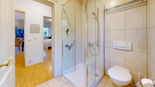 a bathroom with a shower and a toilet at HEIMATEL - Ferienhaus Blümele in Scheidegg