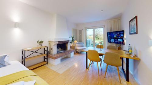 a living room with a table and a fireplace at HEIMATEL - Ferienhaus Blümele in Scheidegg