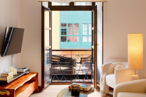 a living room with a door open to a balcony at Dúplex Casco Histórico-Catedral Parking incluido in Oviedo