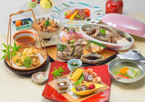 a table with many different types of food on it at Setouchi Kojima Hotel Kurashiki in Kurashiki