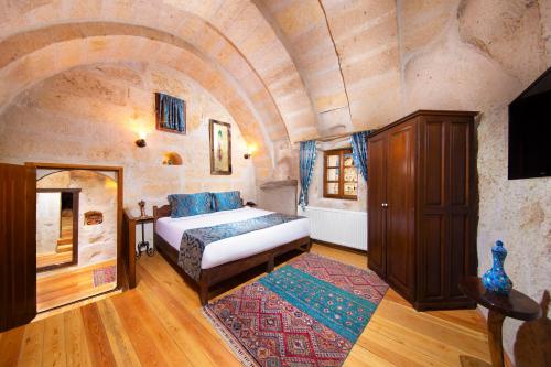 a bedroom with a bed in a large room at Portal Cappadocia Hotel in Ortahisar