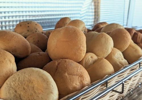 a basket filled with lots of bread in a window at Setouchi Kojima Hotel Kurashiki in Kurashiki