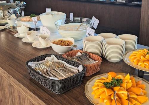 a table with baskets of food and plates of food at Setouchi Kojima Hotel Kurashiki in Kurashiki