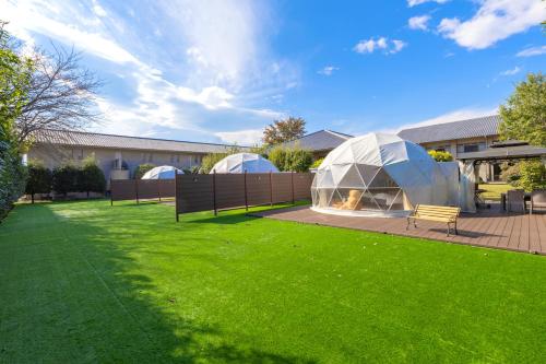 two tents in a yard with green grass at glampark Healthy Pal Gunma in Shibukawa