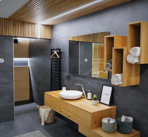a bathroom with a sink and a mirror at Golden Sunset Wellness Suite in Recht