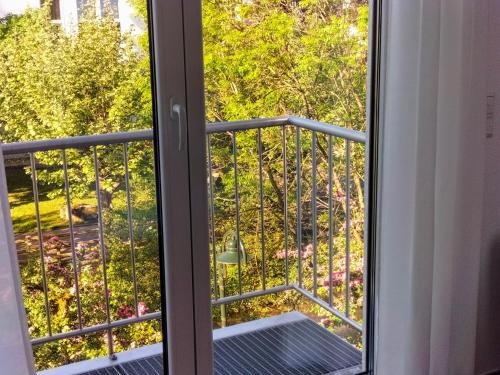 a window with a view of a garden at Alte Stadtmauer - Apartment in Sinsheim