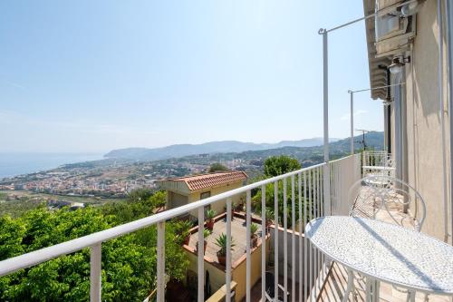 a balcony of a house with a view of the ocean at Villamonte Colonna in Patti