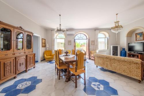 a large living room with a table and chairs at Villamonte Colonna in Patti