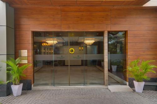 an entrance to a building with a glass door at Lemon Tree Hotel, Noida in Noida
