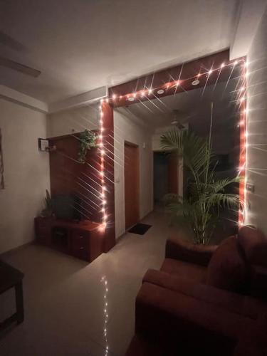 a living room with a couch and christmas lights at Springs Forever in Gachibowli