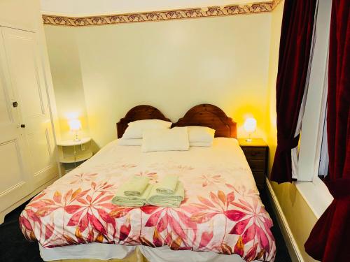 a bedroom with a bed with two pillows on it at The Bliss 9 Home Stay, En-suite, Self check in with smart lock, Non Smoking Home in and out, Zero tolerance for noise after 11pm in Southampton