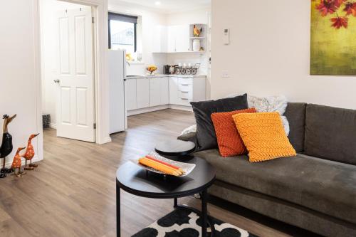 a living room with a couch and a table at Wotama, Macedon B and B, Honour Ave, Mount Macedon in Mount Macedon