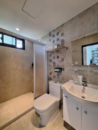 a bathroom with a toilet and a sink at Villa Ten - Swing screw in Guilin