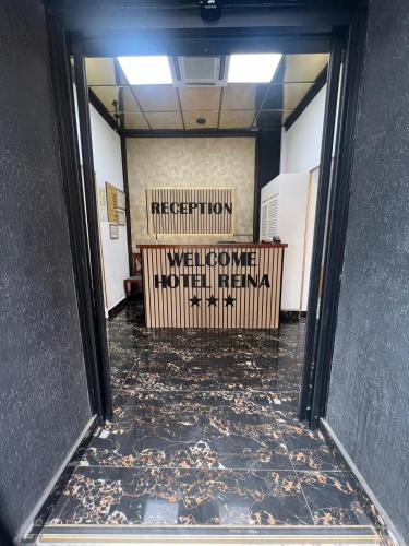 an open door to a hallway with a sign on the wall at Hotel Reina in Bucharest