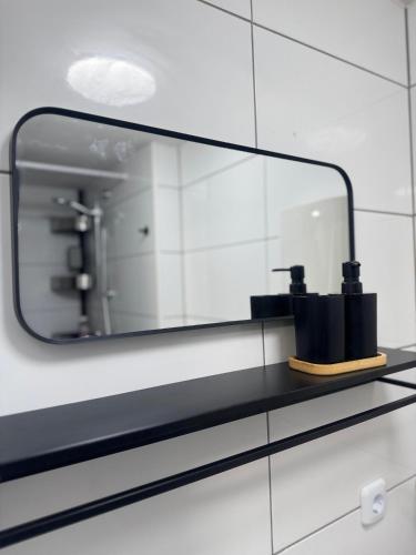 a mirror on a shelf in a bathroom at MaRu Living M71 in Cologne