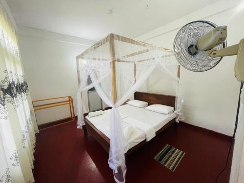 Ένα ή περισσότερα κρεβάτια σε δωμάτιο στο Janaka's House