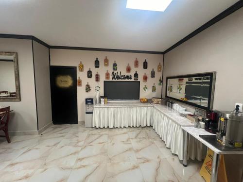 a room with a table and a television on the wall at Hotel Reina in Bucharest