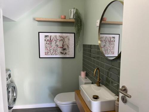 a bathroom with a sink and a toilet and a mirror at Casa da Calabra by Trip2Portugal in Cedovim