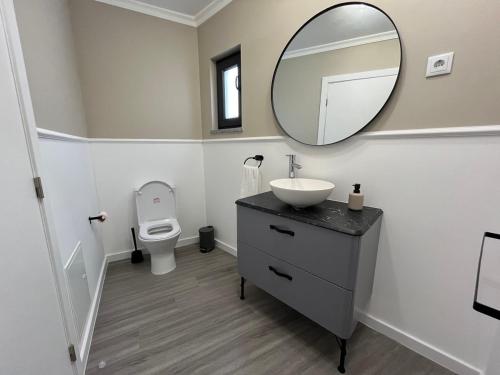 a bathroom with a sink and a mirror on the wall at Casa da Calabra by Trip2Portugal in Cedovim