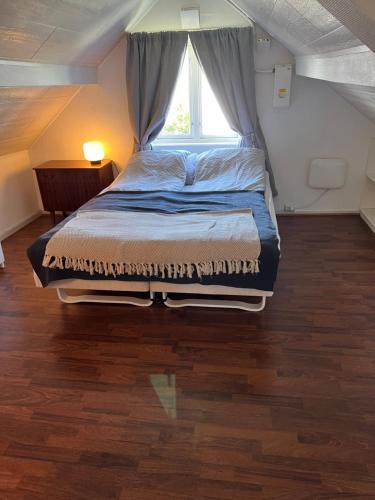 un letto grande in una stanza con una finestra di Lite hus med egen inngang - Sentral beliggenhet a Haugesund