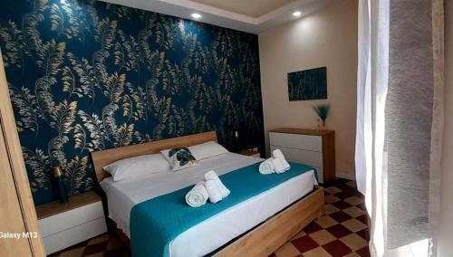 ein Schlafzimmer mit einem Bett mit Handtüchern darauf in der Unterkunft Il palazzo Dei Normanni in Motta SantʼAnastasia