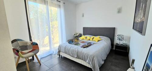 une chambre avec un lit avec des oreillers jaunes dessus dans l'établissement Maison contemporaine avec piscine vue dégagée, à Draguignan