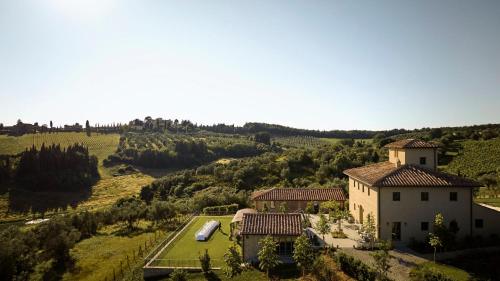 an aerial view of a house in a field at COMO Castello Del Nero in Tavarnelle in Val di Pesa