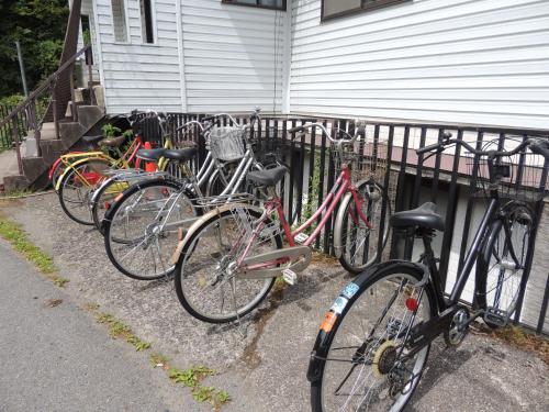 a group of bikes parked next to a fence at Minshuku Kawarabi-so in Nosegawa