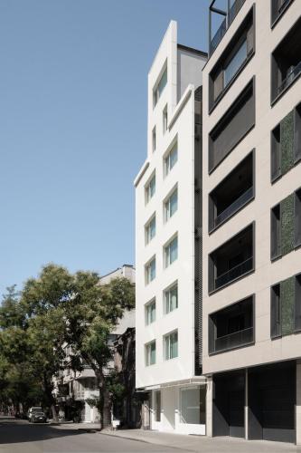 a tall white building on the side of a street at Hotel Hello Plovdiv - Free Parking and Pet Friendly in Plovdiv