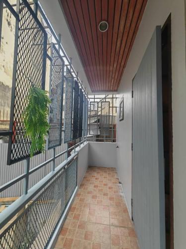 a balcony with a fence and a wooden ceiling at 57 Hidden House BKK Chinatown in Bangkok