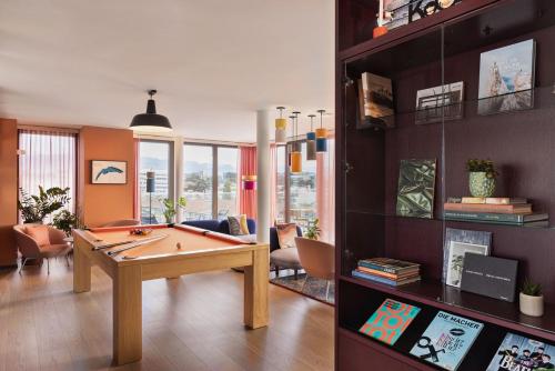 a living room with a pool table in it at Stay KooooK Geneva City - Online Check In in Geneva