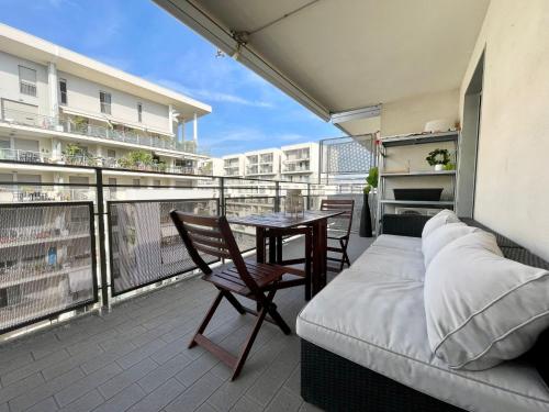 a balcony with a bed and a table and chairs at Santa Giulia Terrace - 15 Mins City Center in Linate