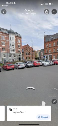 a group of cars parked in a parking lot at aday - Classy 2 bedrooms apartment in the center of Aalborg in Aalborg
