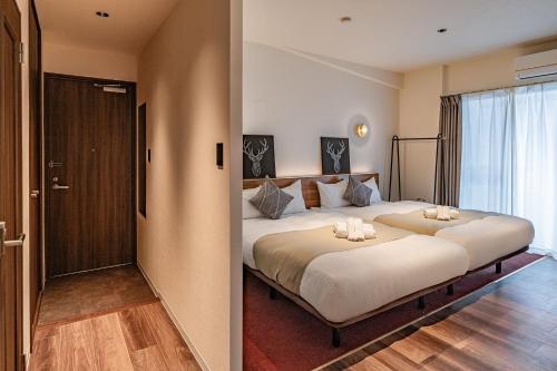 Postel nebo postele na pokoji v ubytování Apartment Hotel 11 Shinsaibashi Amemura