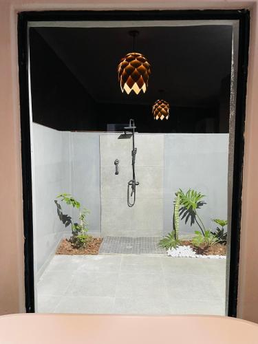 a bathroom with a shower with a shower head at Tranquil Unit in Phalaborwa