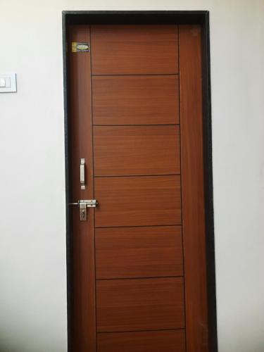 a wooden door in a room at Shriguru Guest House Akkalkot in Akalkot