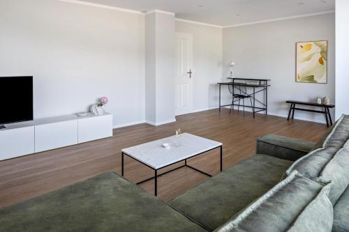 a living room with a couch and a table at Zimis Hofnest in Freiamt