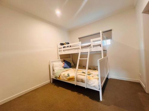 a small room with two bunk beds in it at Beautiful Federation Residence for 16 Guests great for wedding functions in Bunyip