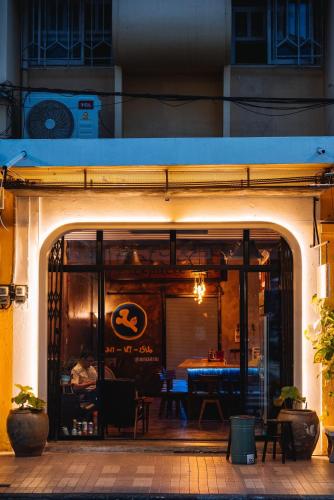 an entrance to a restaurant with a table inside at Hatyai Backpackers Hostel in Hat Yai