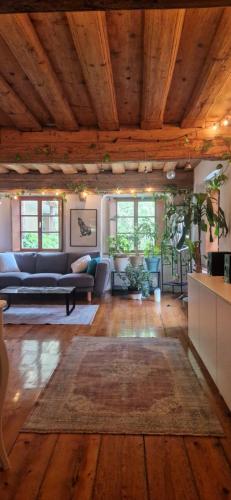 a living room with a couch and a rug at Magic Garden in the heart of Ljubljana in Ljubljana