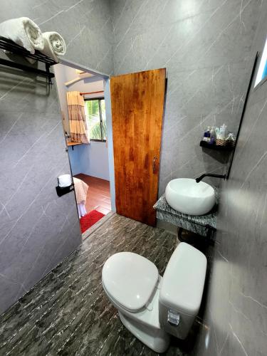 a bathroom with two toilets and a mirror at BONNIE HOMESTAY Mui Ne in Mui Ne