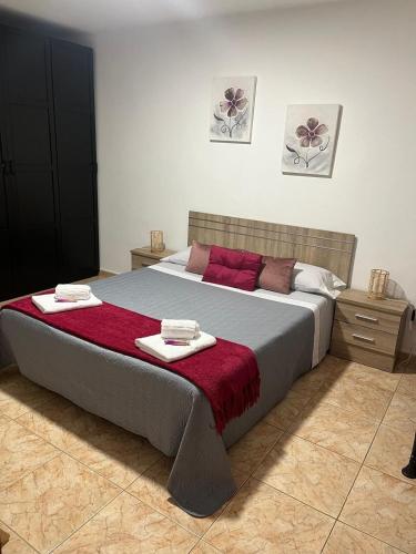 a bedroom with a large bed with two towels on it at Garza Attic House in Ojos de Garza