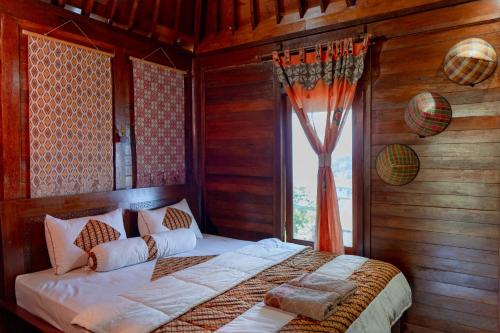 Un ou plusieurs lits dans un hébergement de l'établissement Villa Kuda Sarongge
