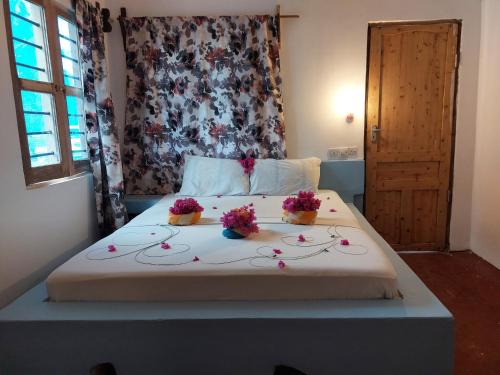 a bedroom with a bed with flowers on it at Stonefish Inn Jambiani in Jambiani